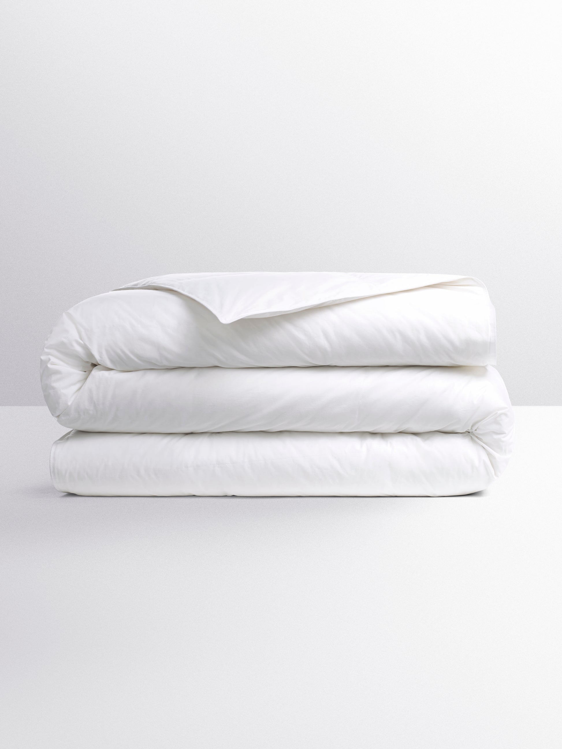 White duvet, folded into three parts on a flat surface.
