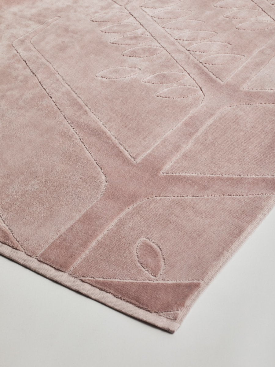 Close-up of a 'Hawaiian Sunrise' beach towel with a textured and embossed Four Seasons logo design.