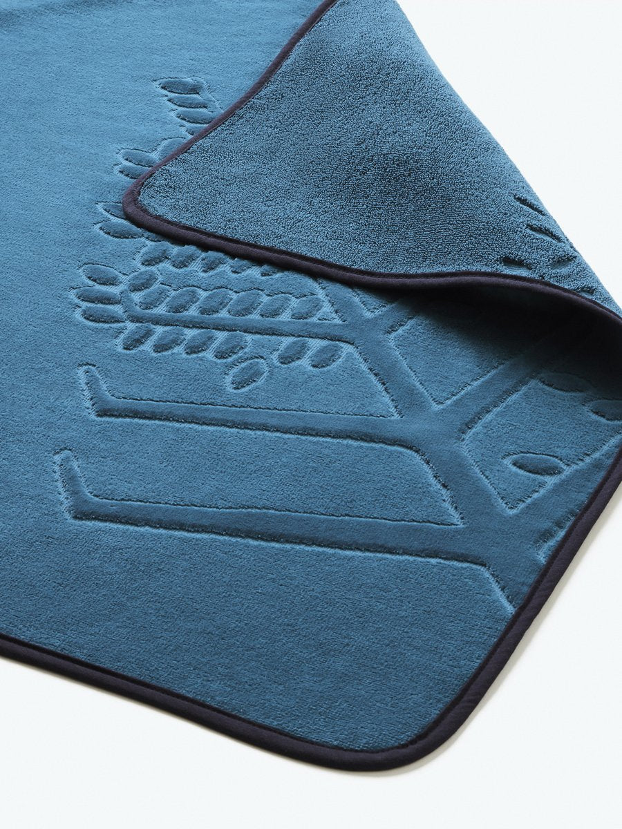 Close-up detail of a "Underwater Blue" hooded baby towel with a textured, embroidered Four Seasons logo.