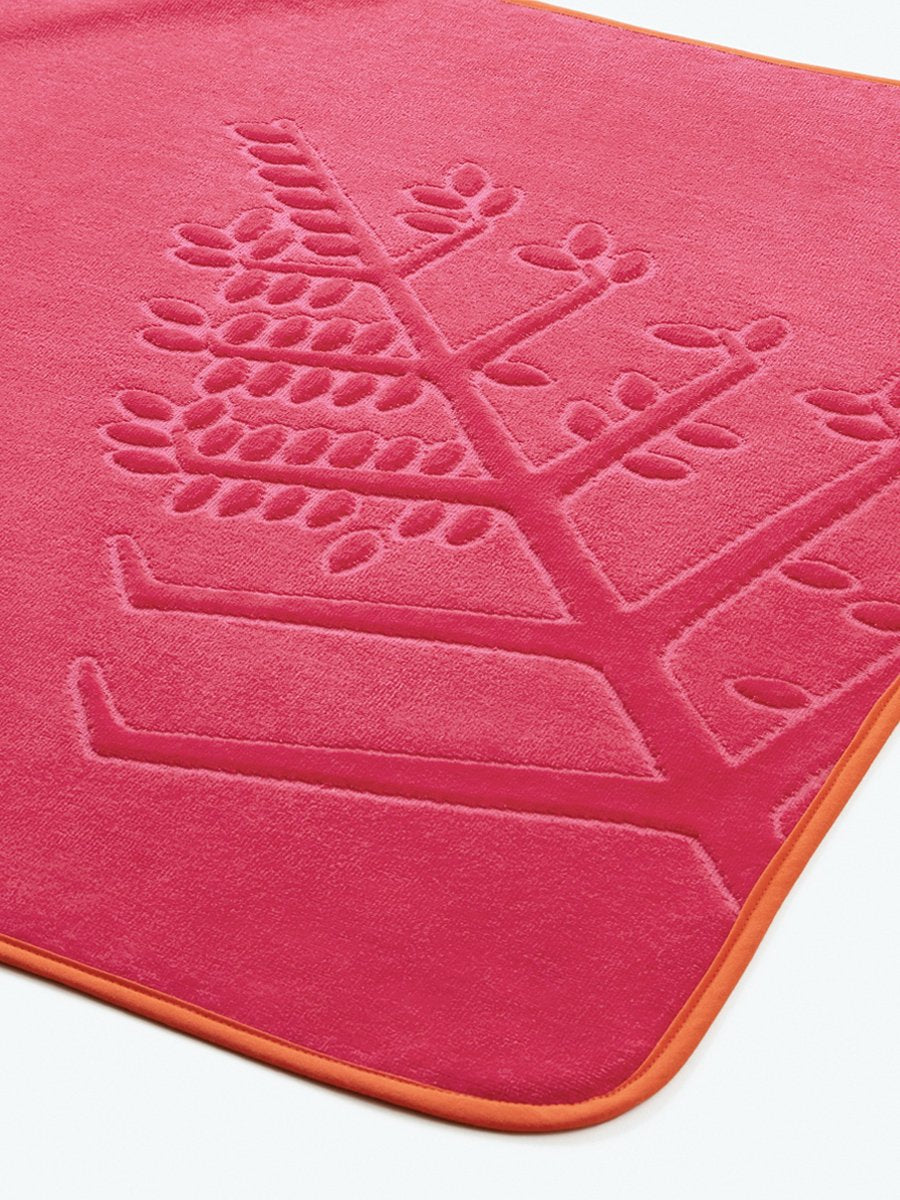 Close-up of a "Coral Reef Pink" hooded baby towel with an embroidered Four Seasons logo.