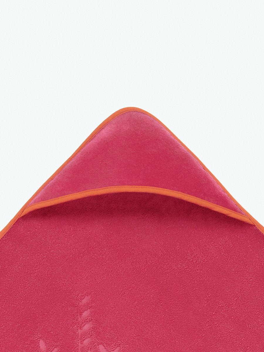 Close-up of the hooded end of a "Coral Reef Pink" baby towel.
