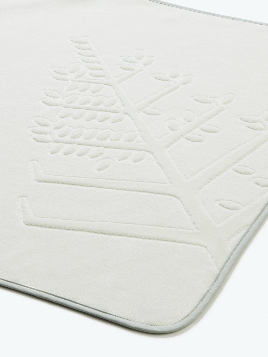 Close-up of a "Safari Sage" hooded baby towel with an embroidered Four Seasons logo.