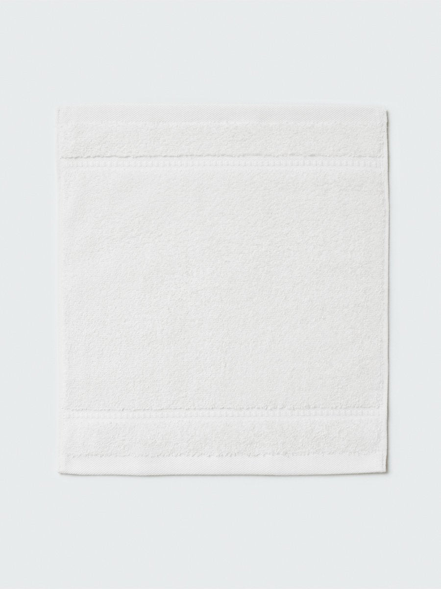 Close-up of a "Signature White" colored bath wash cloth, visible fabric