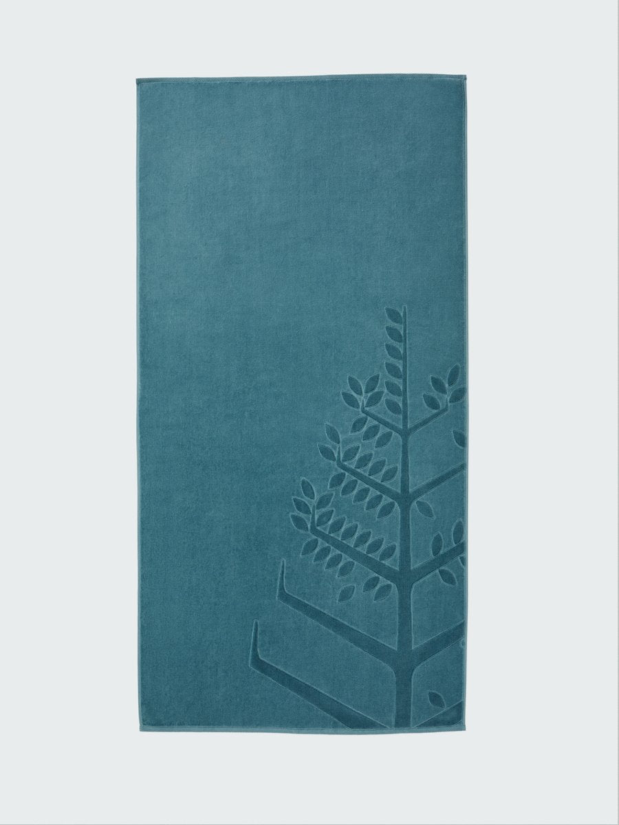 A 'Polynesian Lagoon' beach towel with the Four Seasons logo embossed on it.
