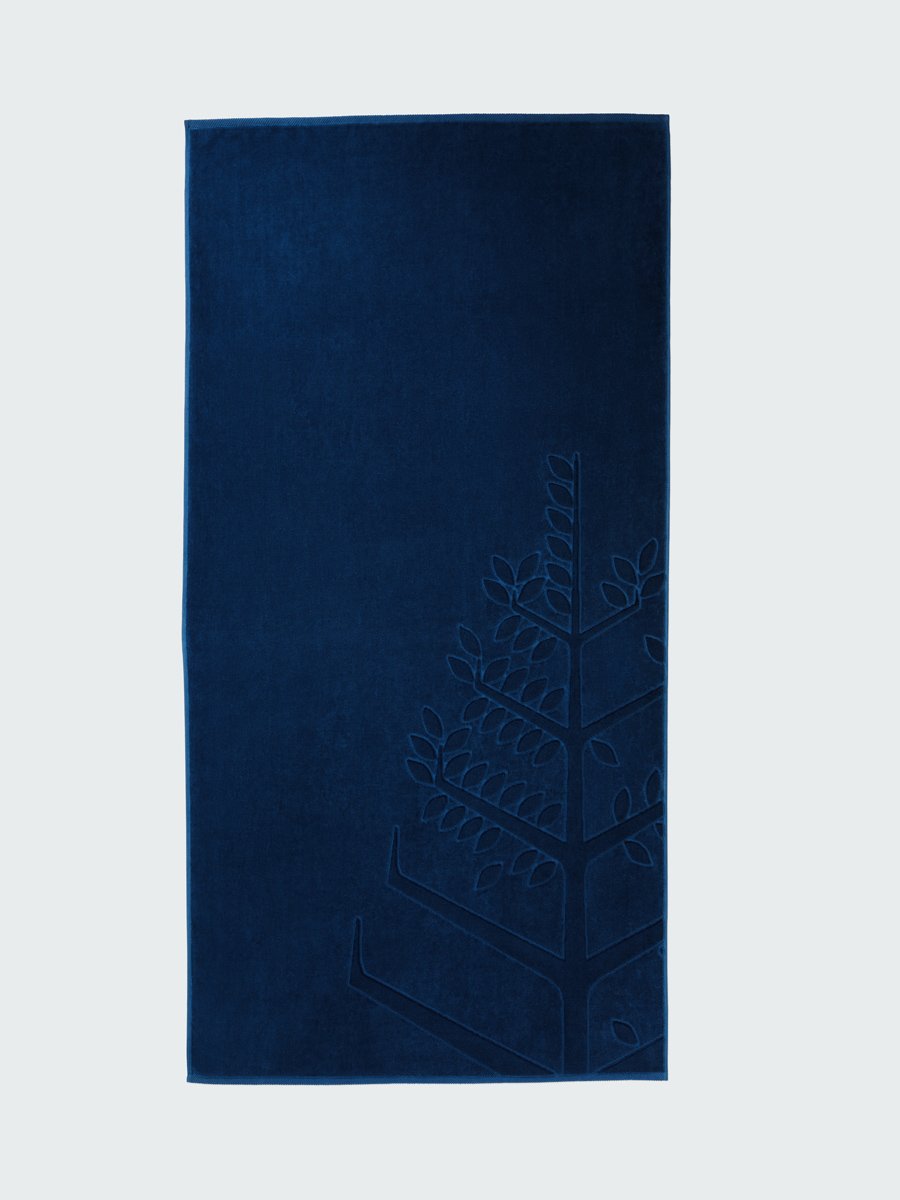 A 'Riviera Navy' beach towel with the Four Seasons logo embossed on it.