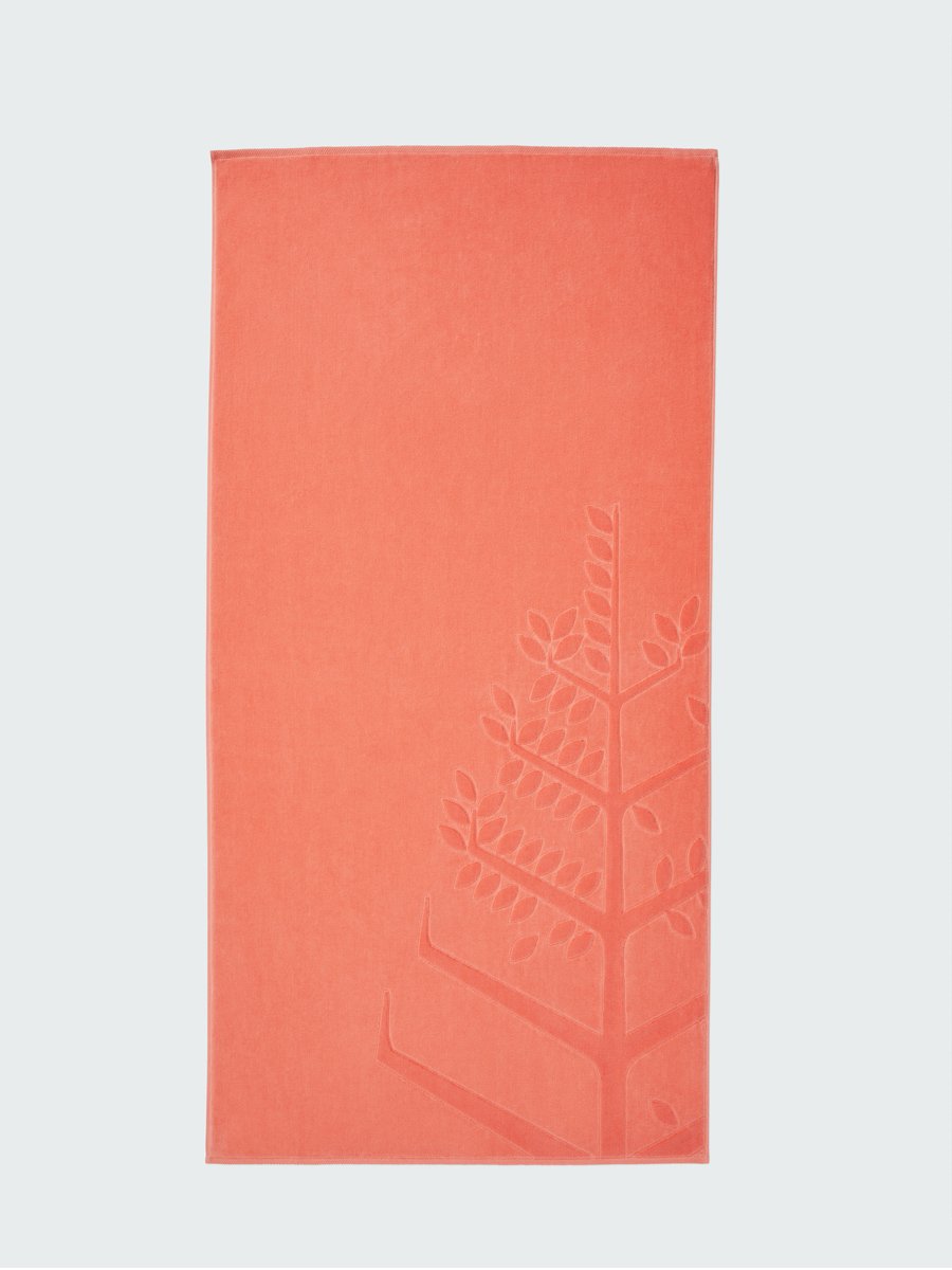 A 'Red Sea Coral' beach towel with the Four Seasons logo embossed on it.