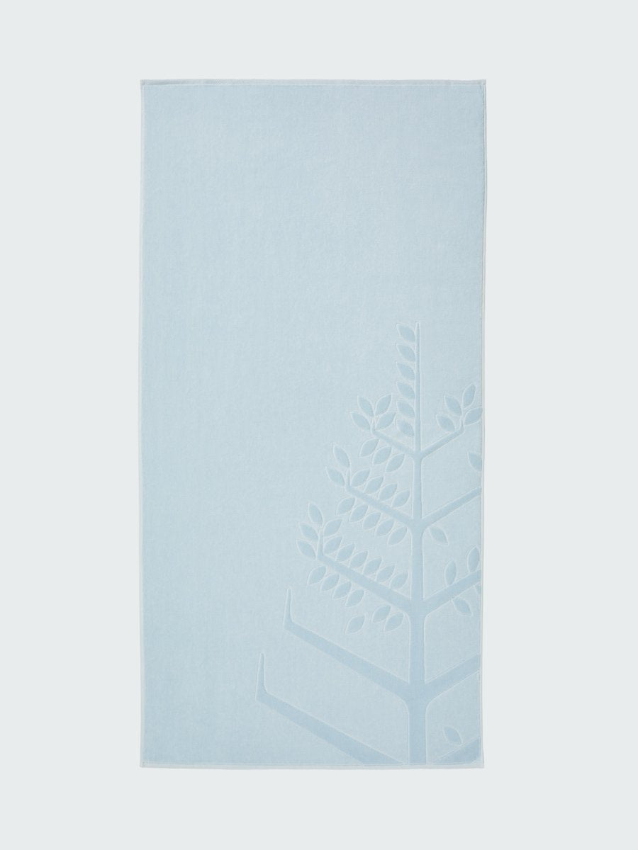 A 'Maldivian Atoll' beach towel with the Four Seasons logo embossed on it."