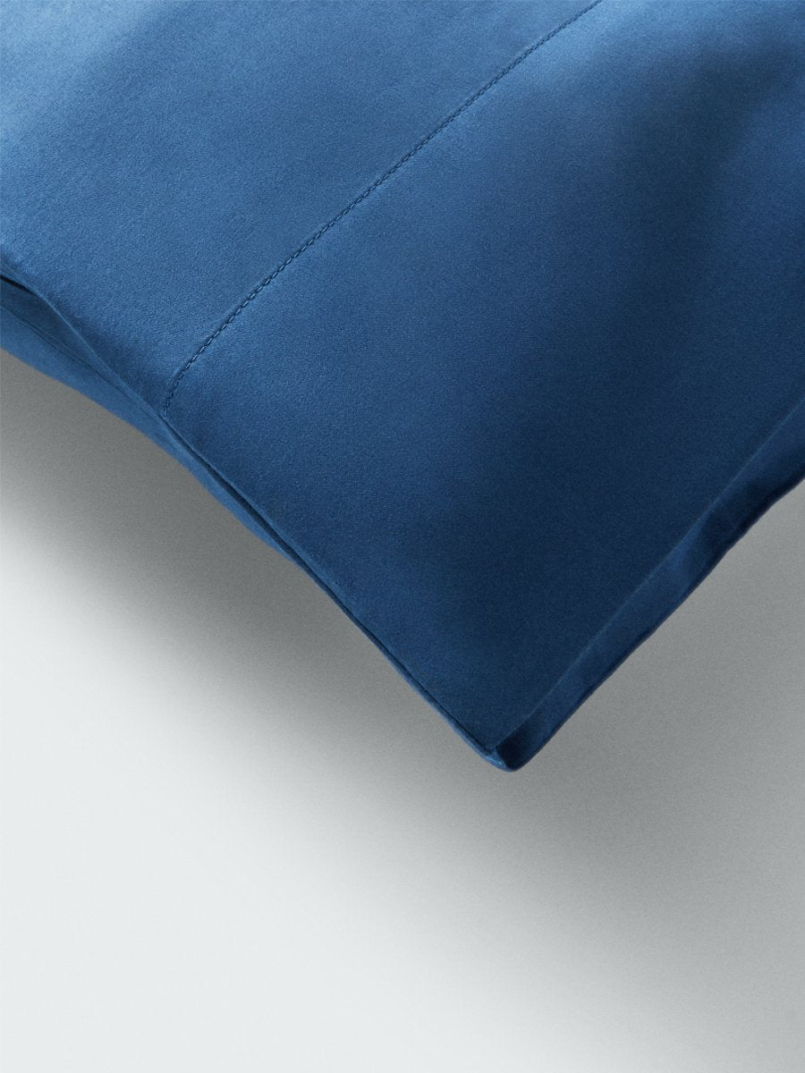Part of a pillow with a pillowcase in Riviera Navy color.