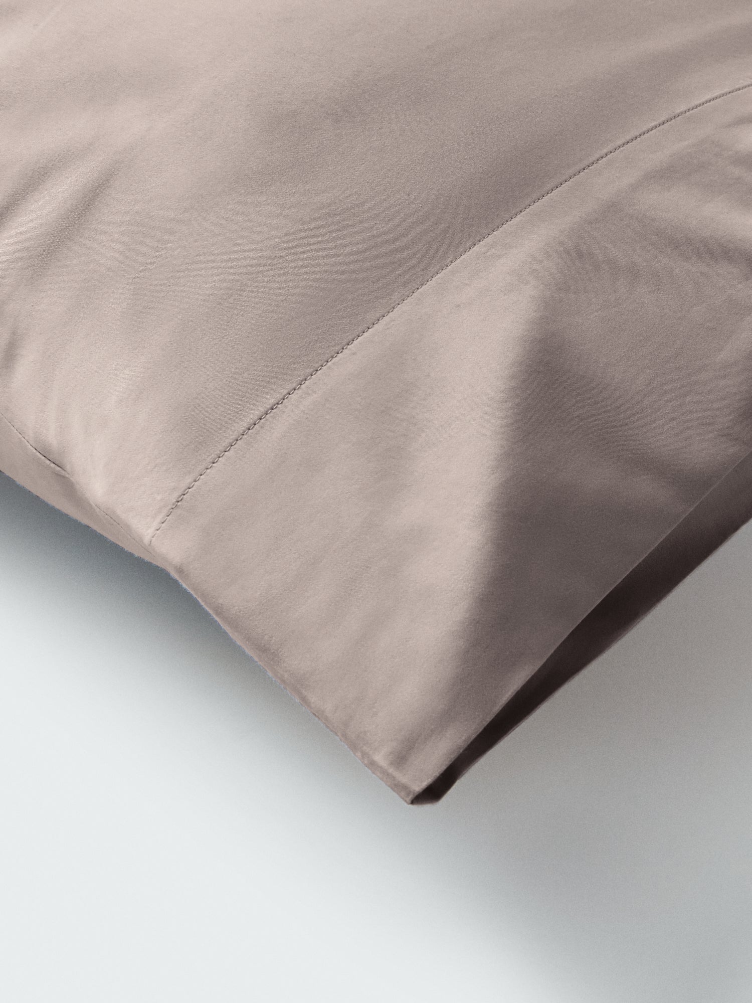 Part of a pillow with a pillowcase in Moroccan Sand color.