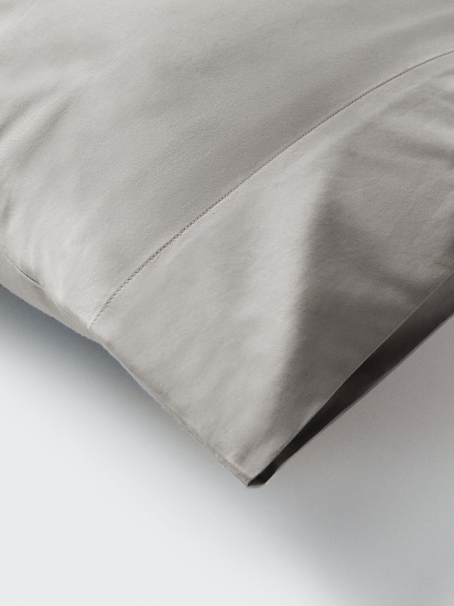 Part of a pillow with a pillowcase in Spanish Slate color.