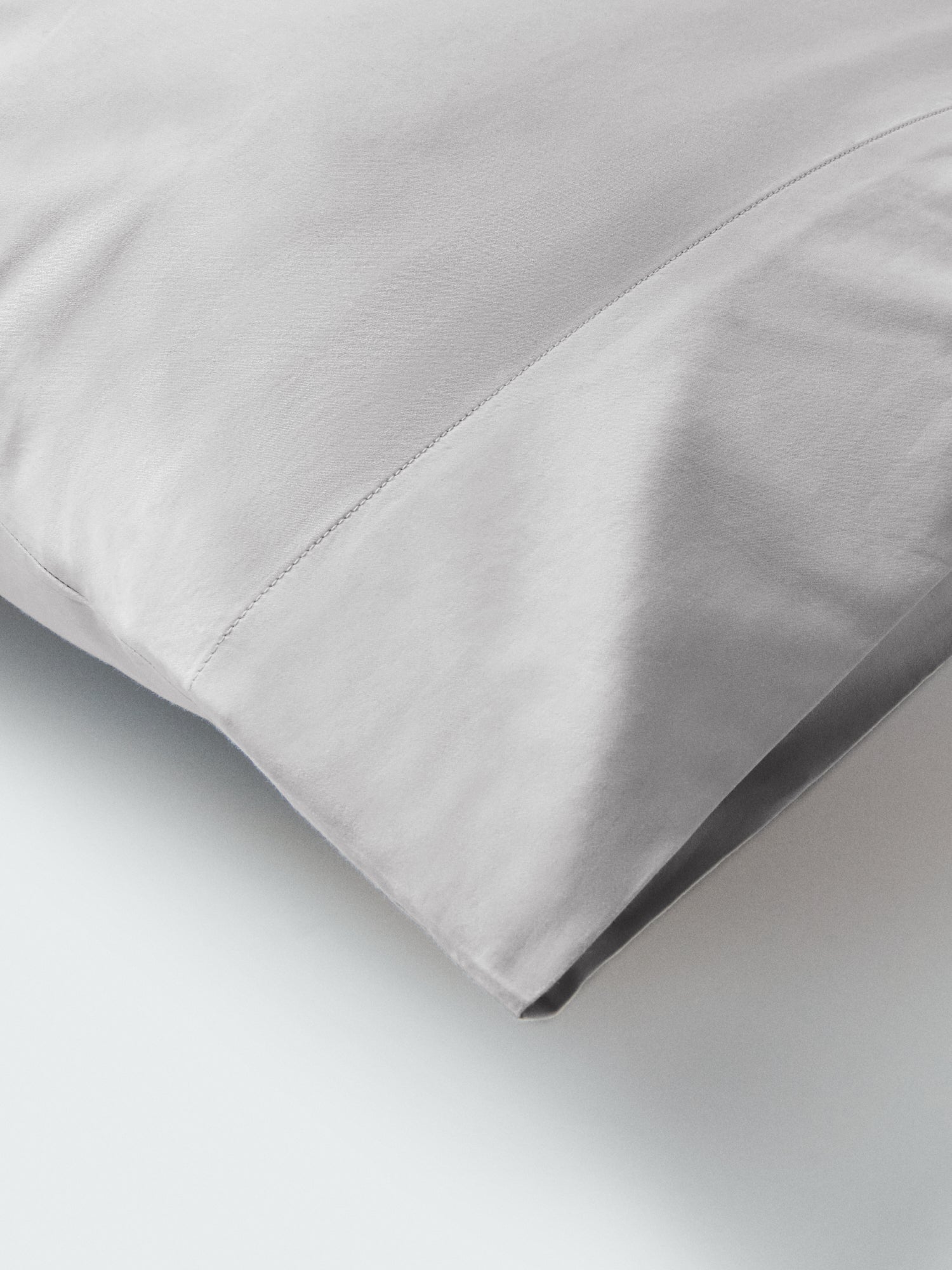 Part of a pillow with a pillowcase in Turkish Silver color.