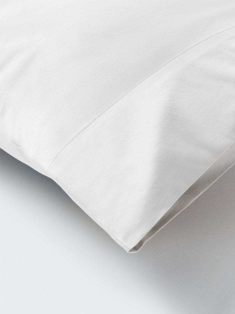 Part of a pillow with a pillowcase in Signature White color.