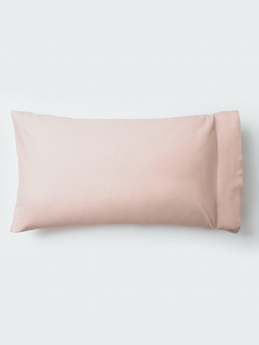 A pillow with an elegant Kyoto Blush color pillowcase.