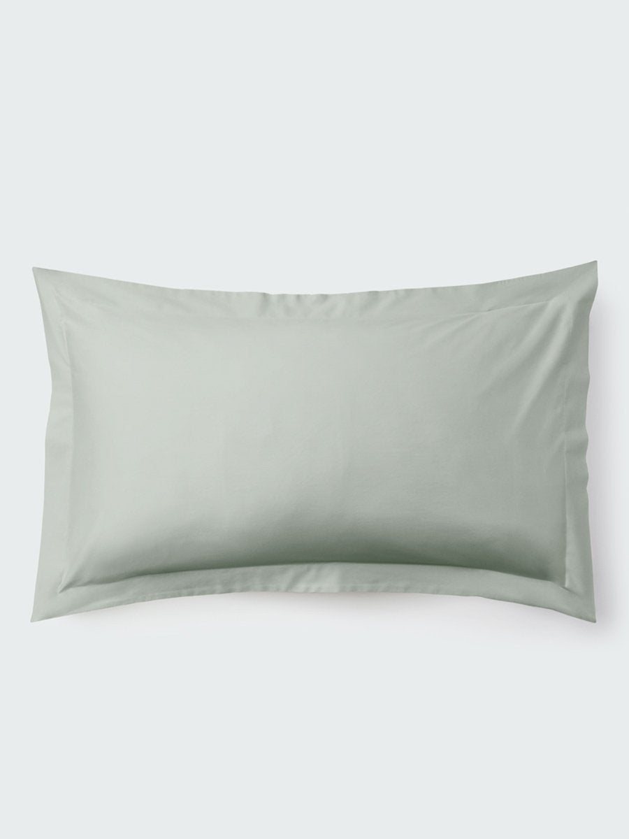 A rectangular pillow with a Florentine Sage color pillowcase, featuring a delicate embroidery that runs along the entire edge.