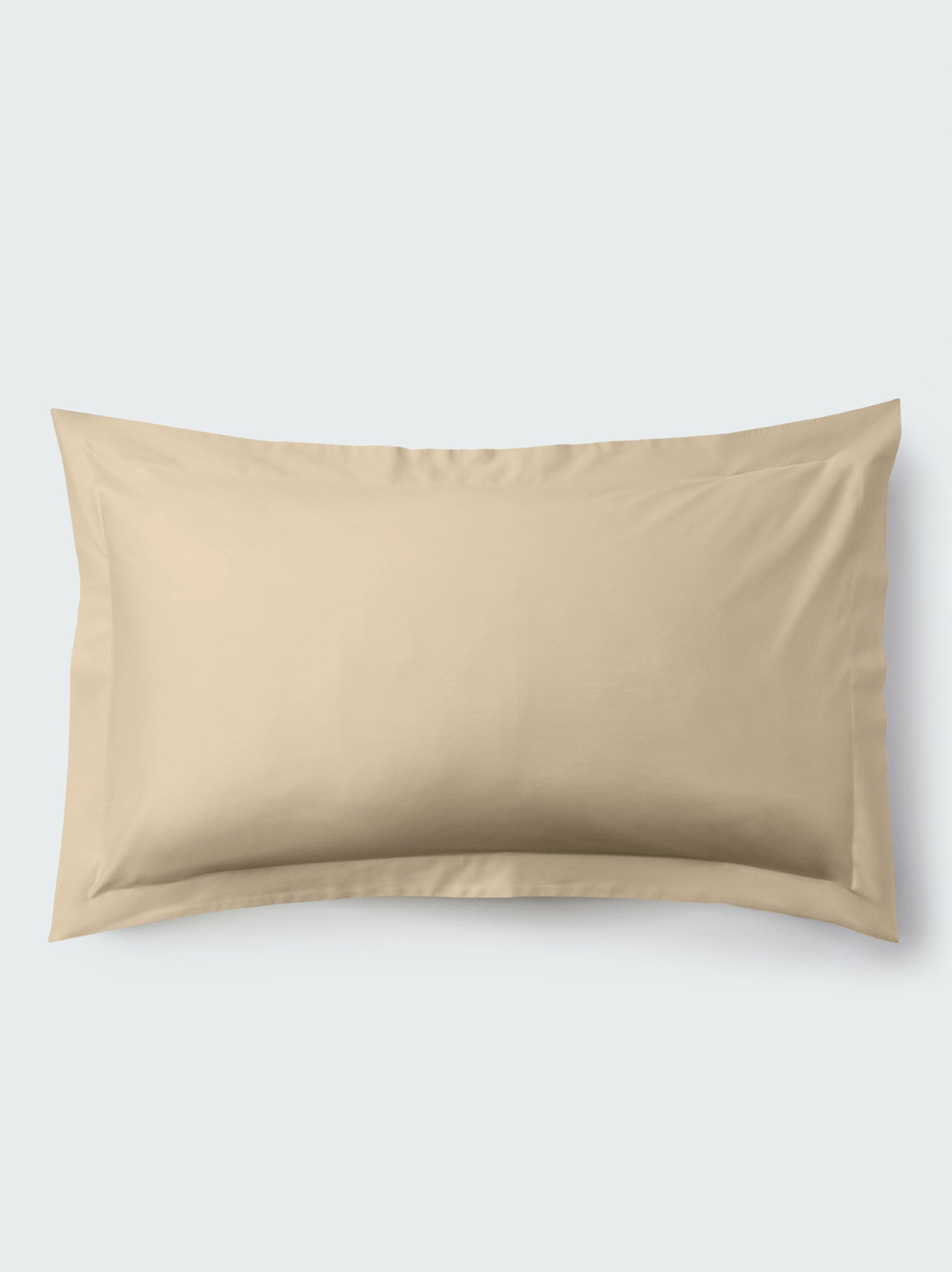 A rectangular pillow with an Egyptian Camel color pillowcase, featuring a delicate embroidery that runs along the entire edge.