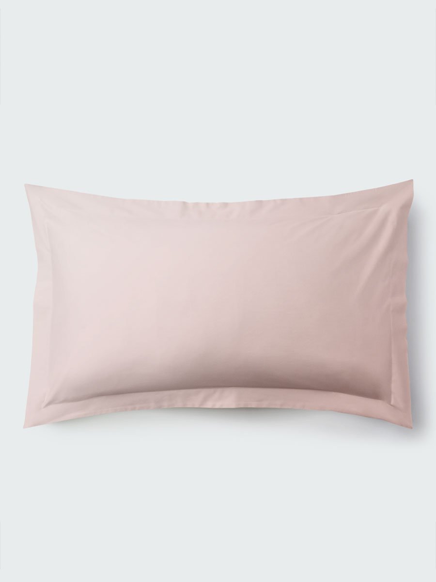 A rectangular pillow with a Kyoto Blush color pillowcase, featuring a delicate embroidery that runs along the entire edge.