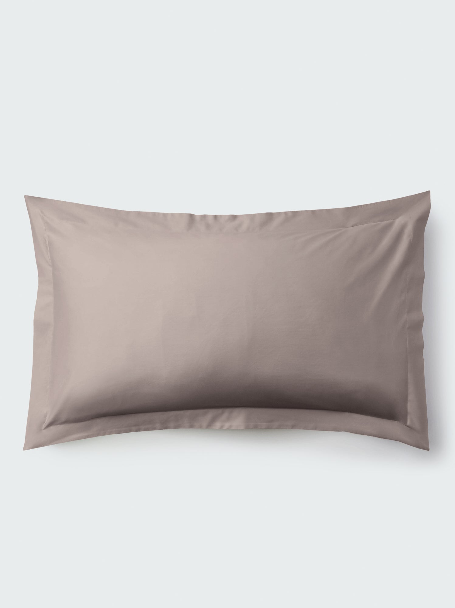 A rectangular pillow with a Moroccan Sand color pillowcase, featuring a delicate embroidery that runs along the entire edge.