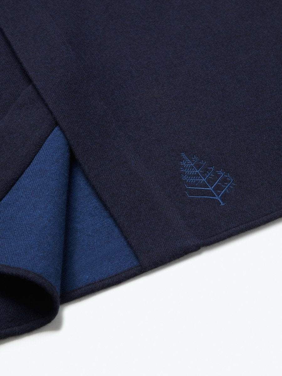 The exterior of the robe showcases a soft and uniform Riviera Navy tone, while the interior lining is white, creating a pleasing visual contrast.