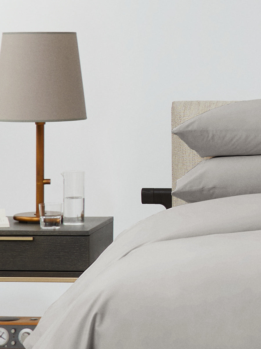 Bed dressed with a duvet in Spanish Slate color and two matching pillows.