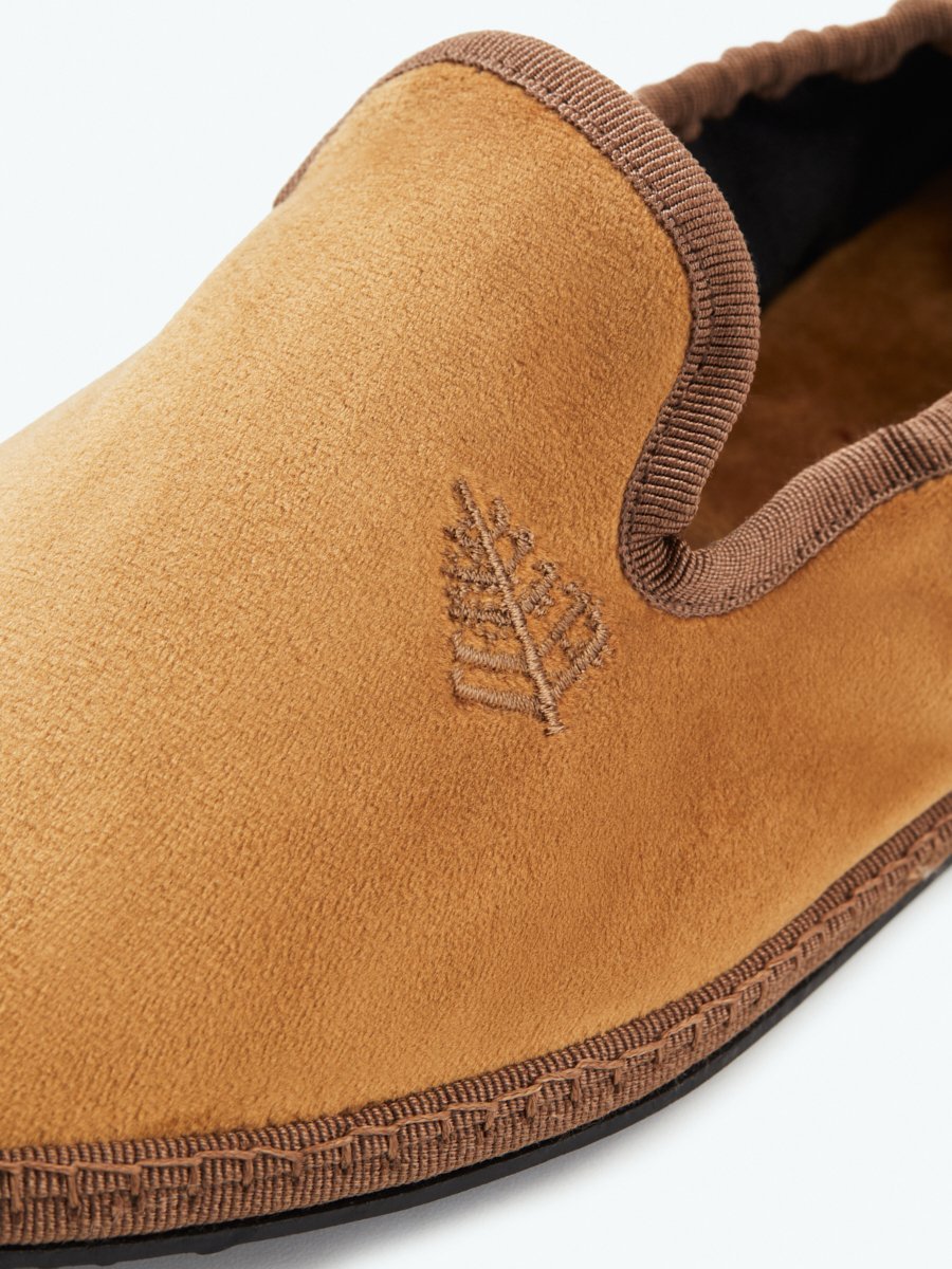 Close-up of the Four Seasons Velvet Slippers in Egyptian Camel, showcasing the embroidered Four Seasons logo.