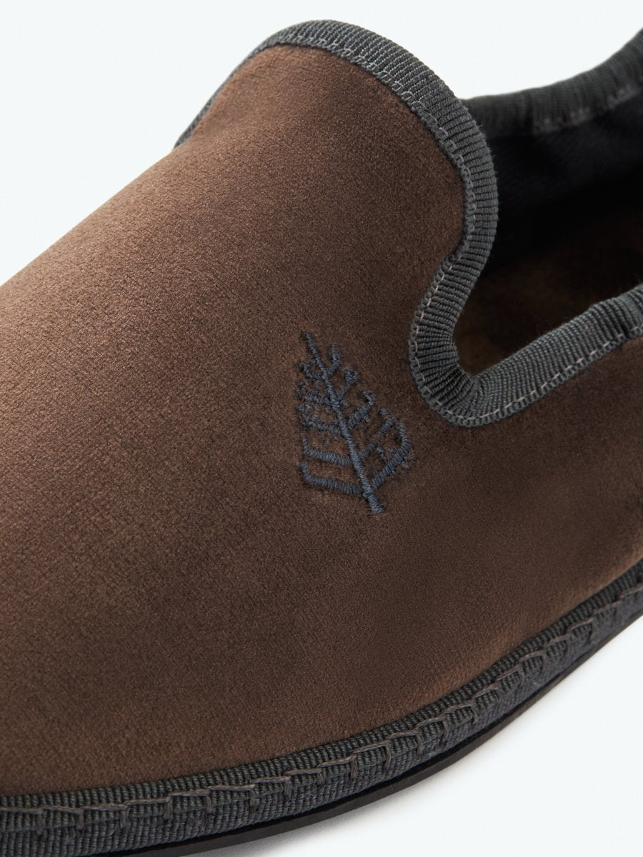 Close-up of the Four Seasons Velvet Slippers in Hampshire Charcoal, showcasing the embroidered Four Seasons logo.
