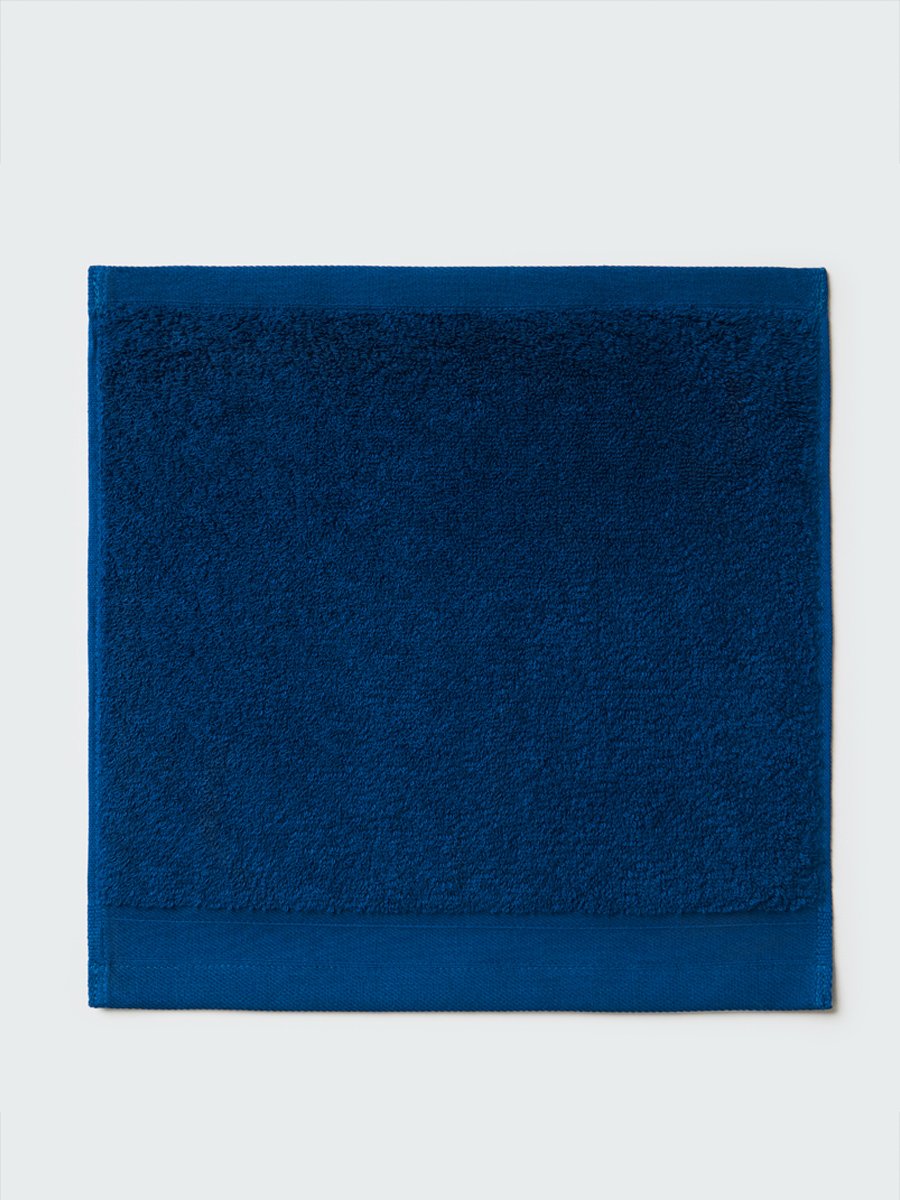 Close-up of a "Riviera Navy" colored bath wash cloth, visible fabric