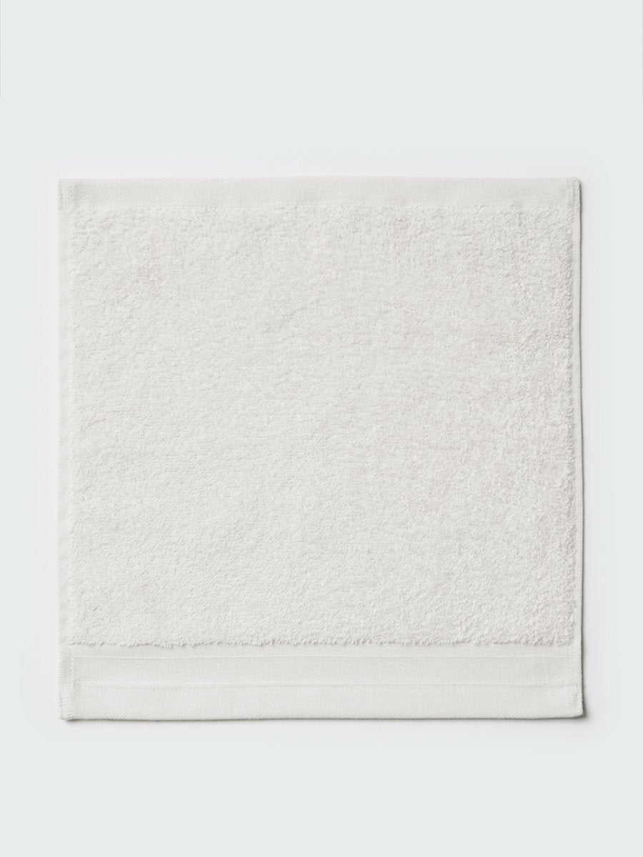 Close-up of a "Signature White"; colored bath wash cloth, visible fabric