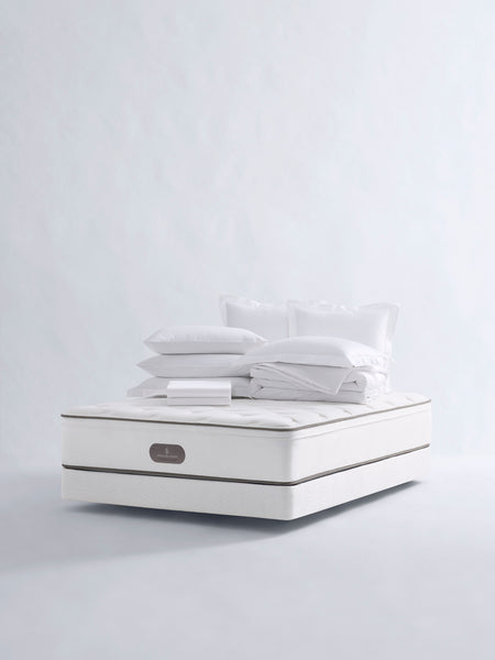 Four Seasons Bedding Set. The set includes a white mattress, a white comforter, and several white pillows, all neatly arranged on a white background.