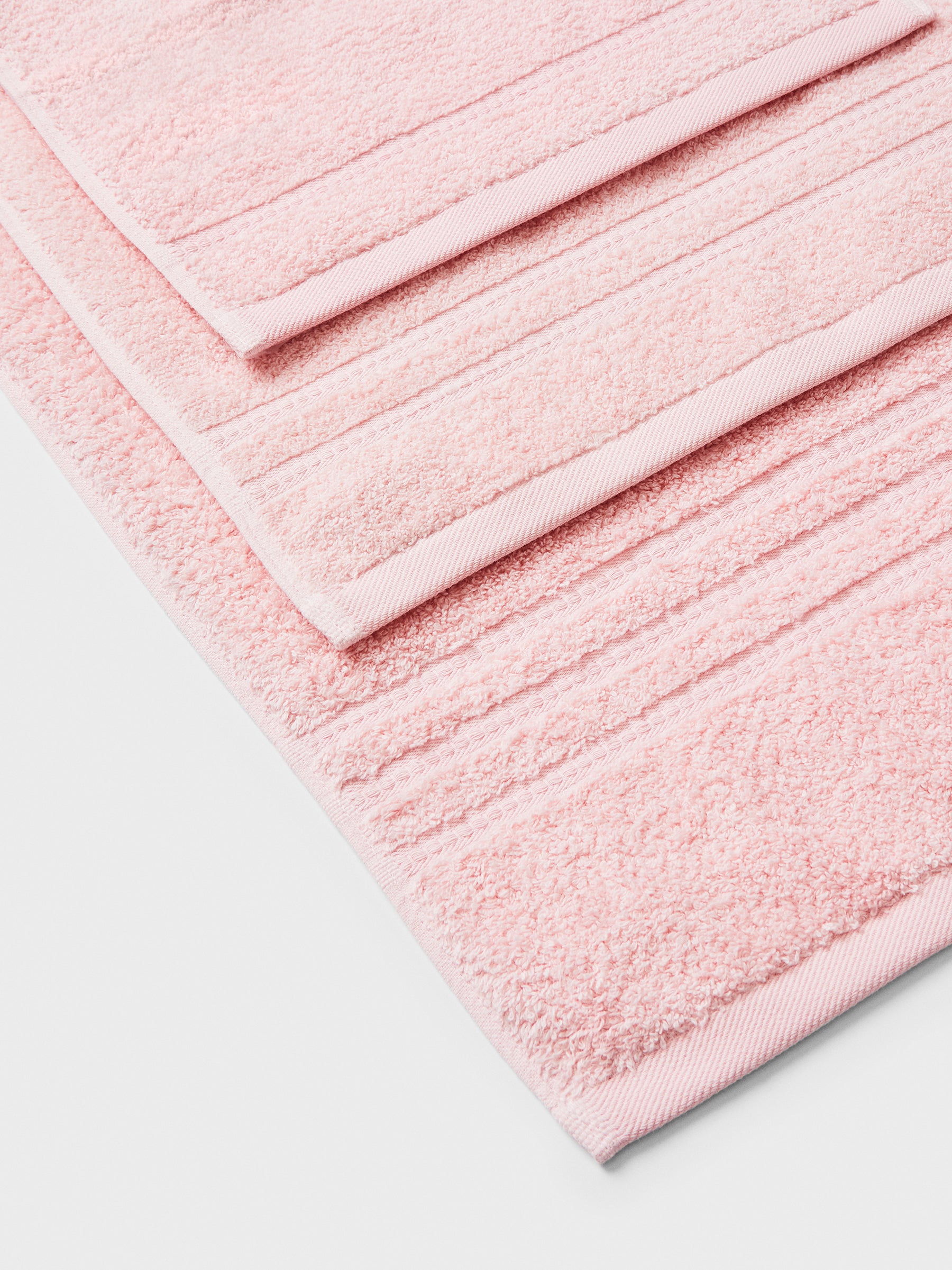 towel set in Kyoto Blush, finished with a patterned dobby border.