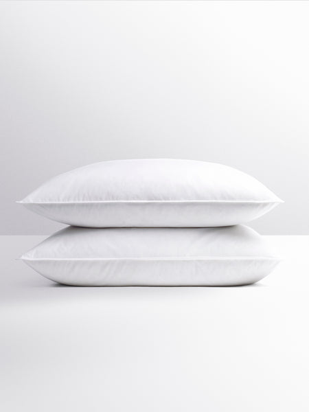 Two white pillows stacked together, soft and fluffy.