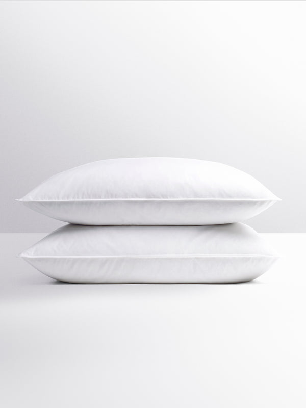 Front view of two white pillows stacked, soft and fluffy.