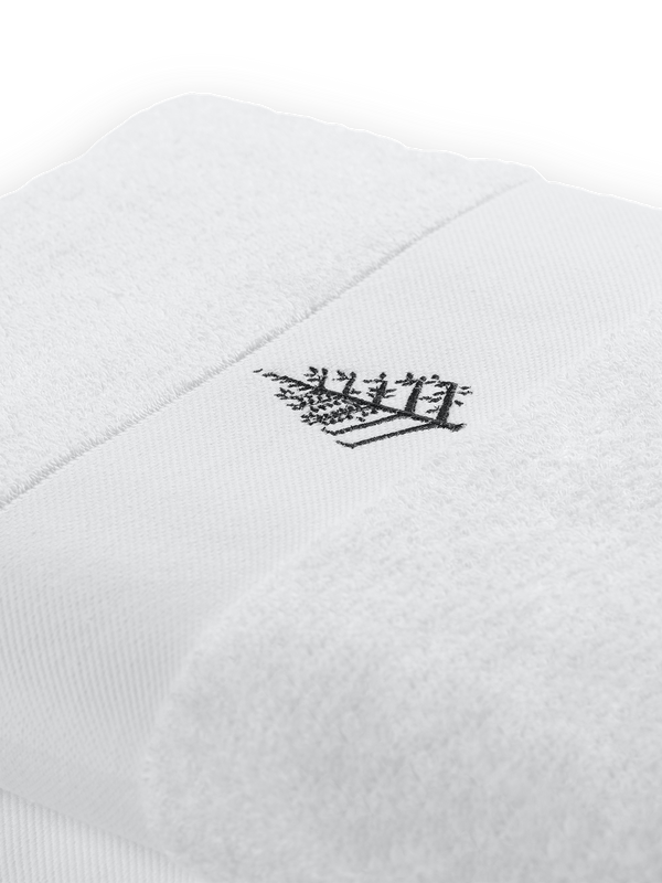 Front fold of a white pool towel with embroidered Four Seasons logo.