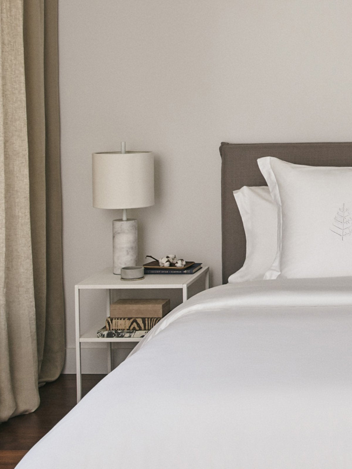 Luxurious white down duvet folded neatly on a bed, showcasing its premium quality and craftsmanship.