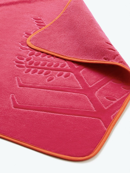 Close-up detail of a "Coral Reef Pink" hooded baby towel with a textured, embroidered Four Seasons logo.