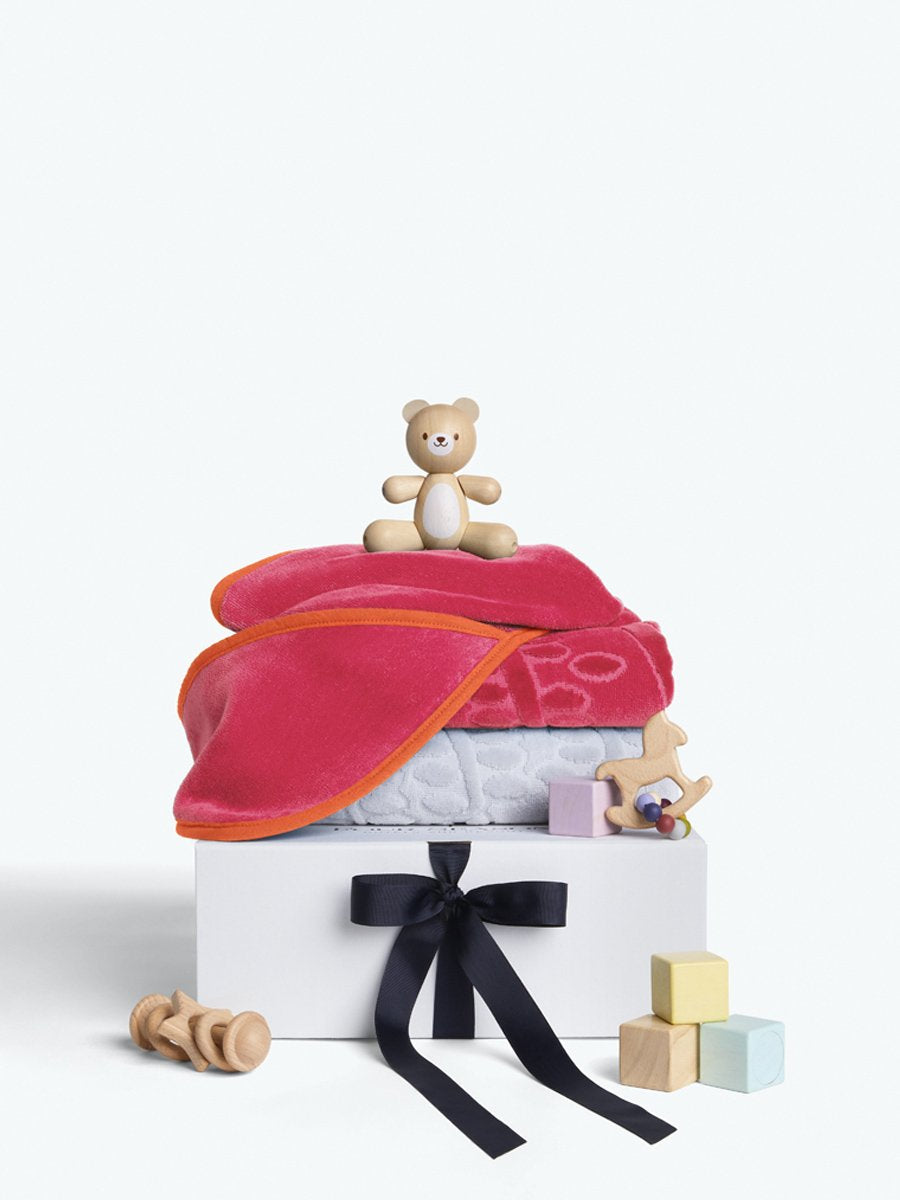 A gift box that includes a set of luxurious baby towels, including a hooded towel
