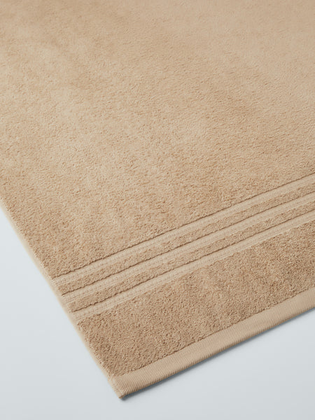 plush, folded bath sheets in a warm, inviting "Egyptian Camel" color. The towels have a thick, textured weave and subtle stripes