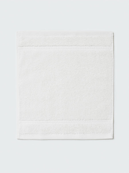 Close-up of a "Signature White" colored bath wash cloth, visible fabric