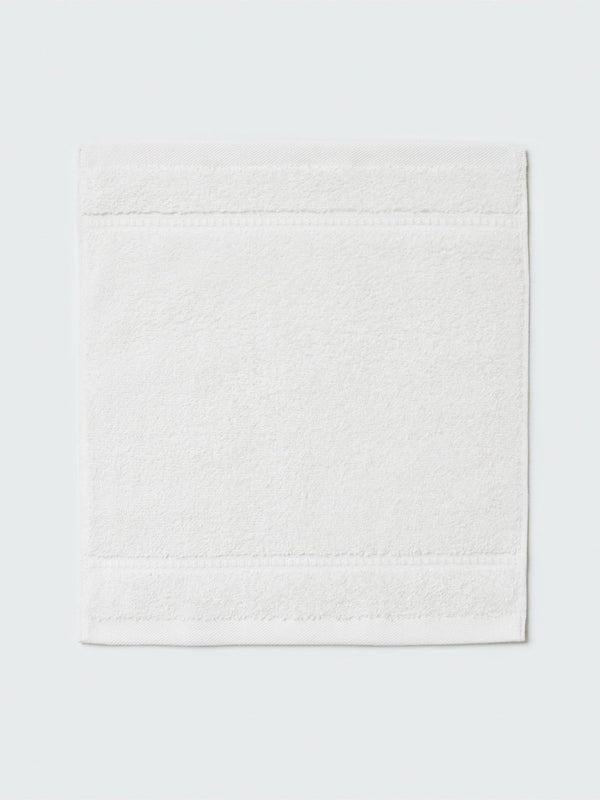 Close-up of a "Signature White" colored bath wash cloth, visible fabric
