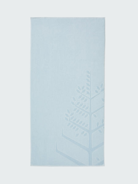 A 'Maldivian Atoll' beach towel with the Four Seasons logo embossed on it."
