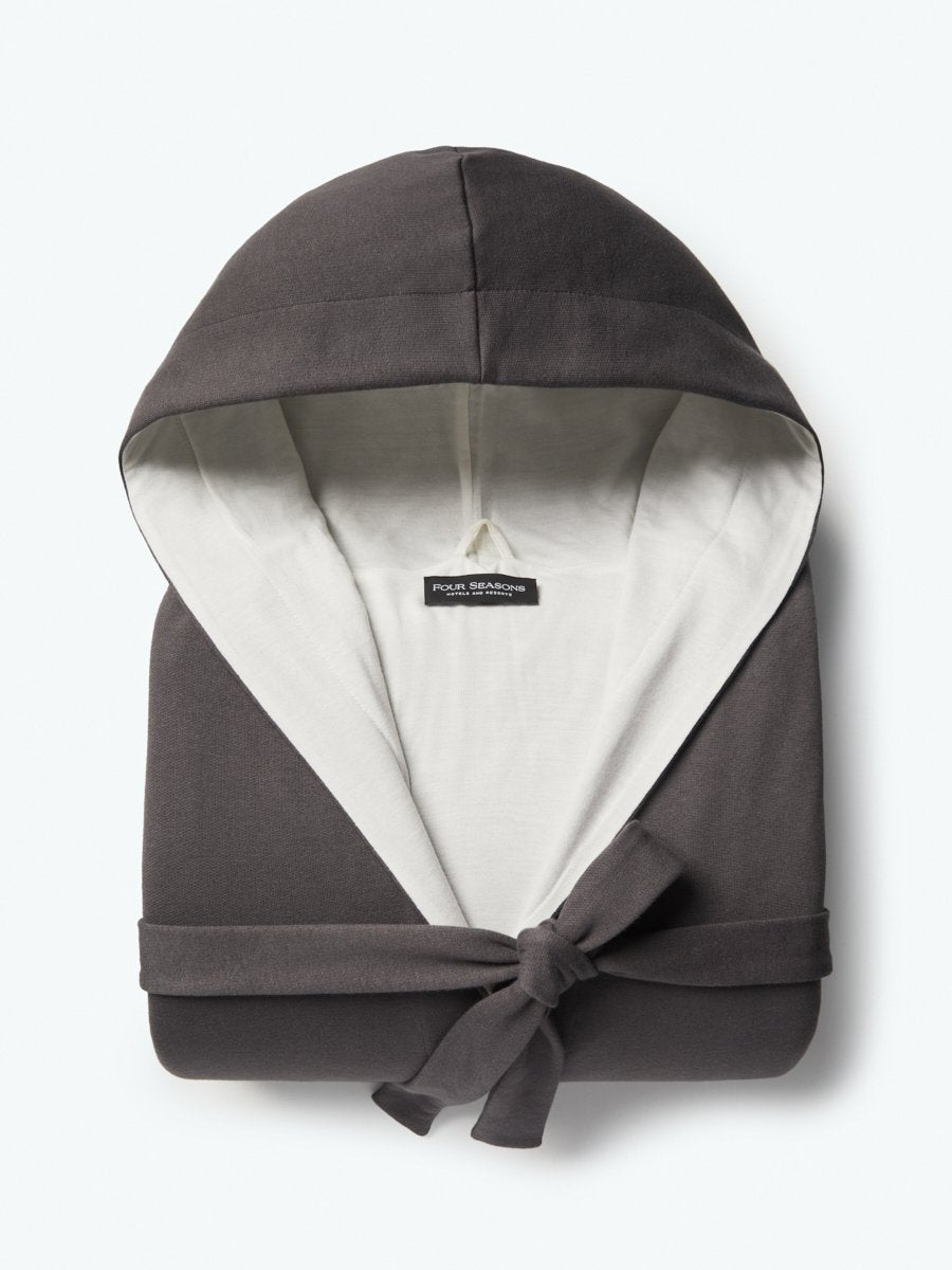 The Four Seasons Hooded Robe features a mid-length design with a bamboo cotton interior for exceptional softness and comfort. The exterior showcases a Hampshire Charcoal tone in a neutral colorway