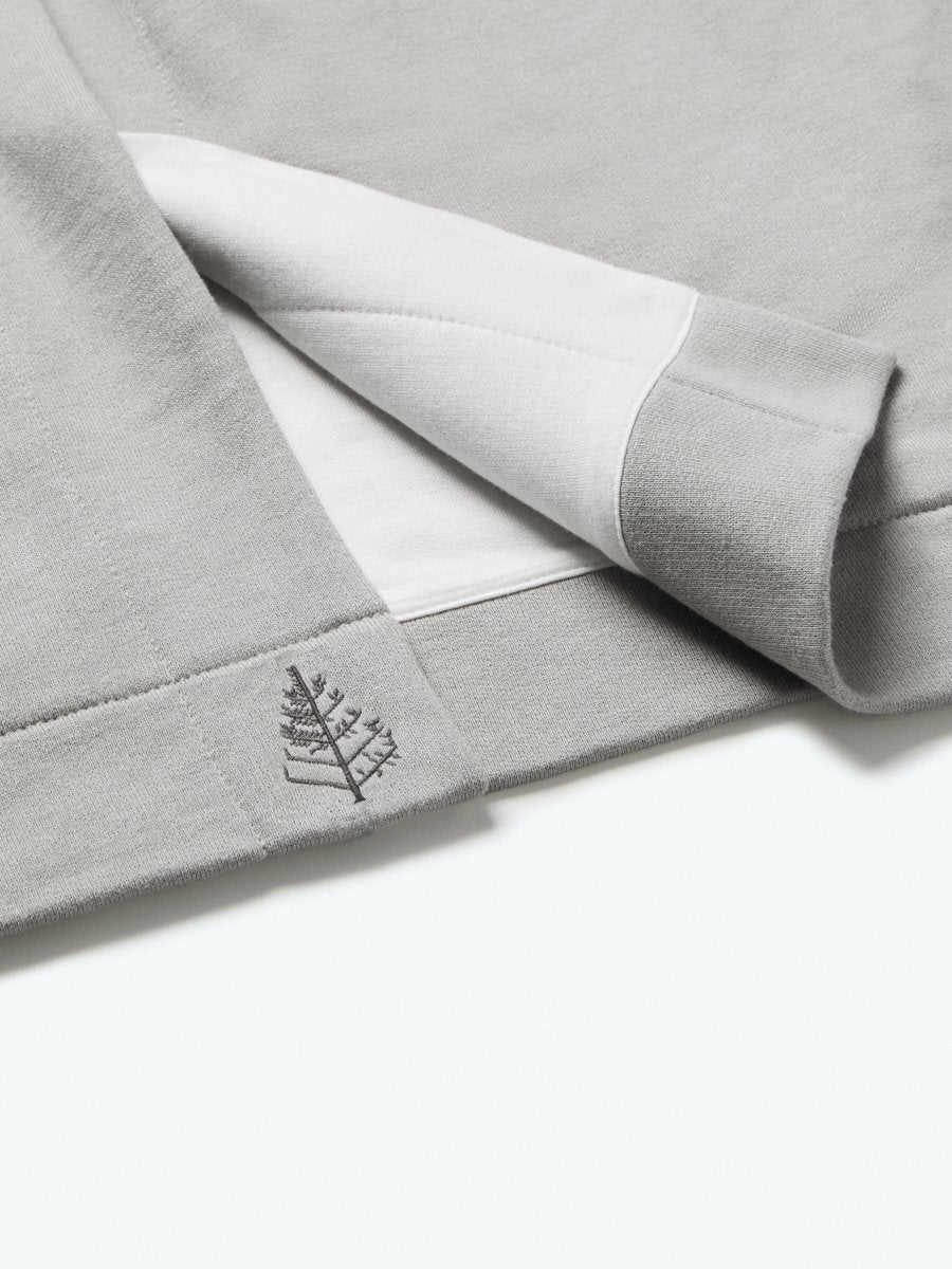 The exterior of the robe showcases a soft and uniform gray tone, while the interior lining is white, creating a pleasing visual contrast.