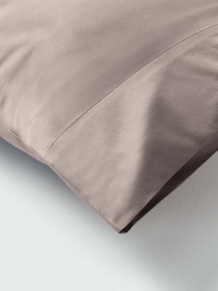 Part of a pillow with a pillowcase in Moroccan Sand color.