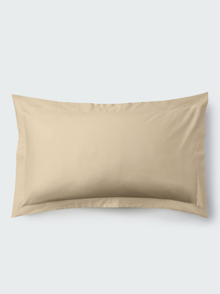 A rectangular pillow with an Egyptian Camel color pillowcase, featuring a delicate embroidery that runs along the entire edge.