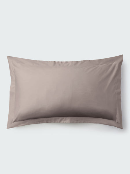 A rectangular pillow with a Moroccan Sand color pillowcase, featuring a delicate embroidery that runs along the entire edge.