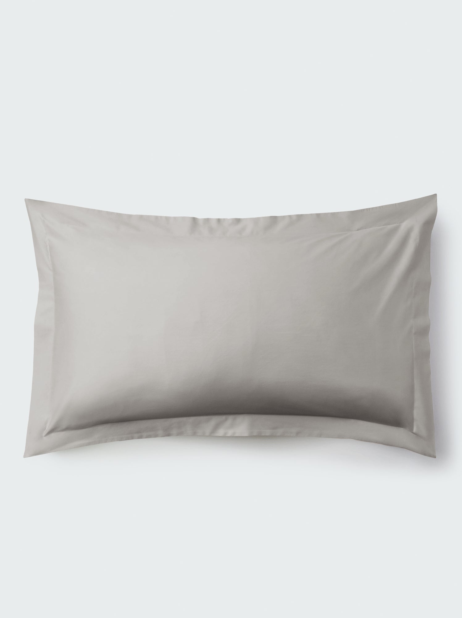 A rectangular pillow with a Spanish Slate color pillowcase, featuring a delicate embroidery that runs along the entire edge.
