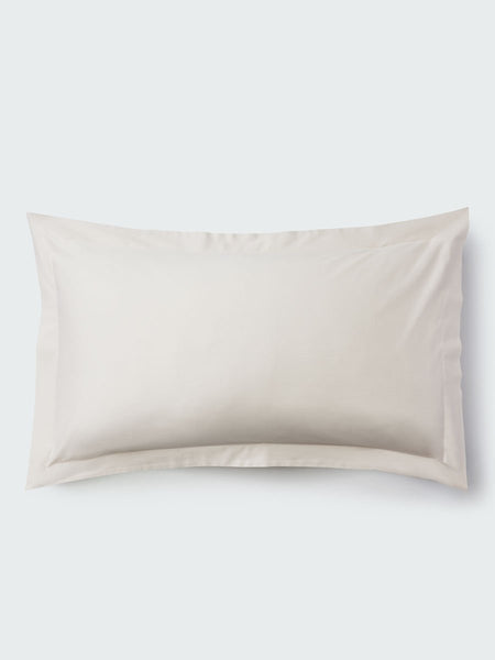 A rectangular pillow with a Balinese Pearl color pillowcase, featuring a delicate embroidery that runs along the entire edge.