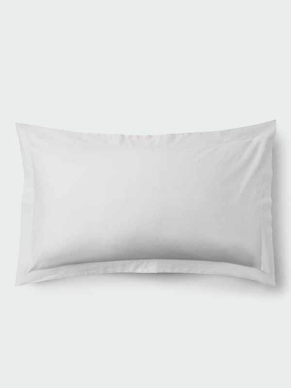 A rectangular pillow with a Signature White color pillowcase, featuring a delicate embroidery that runs along the entire edge.
