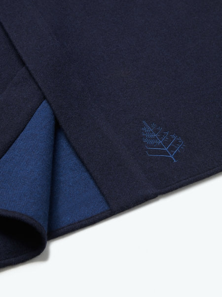The exterior of the robe showcases a soft and uniform Riviera Navy tone, while the interior lining is white, creating a pleasing visual contrast.