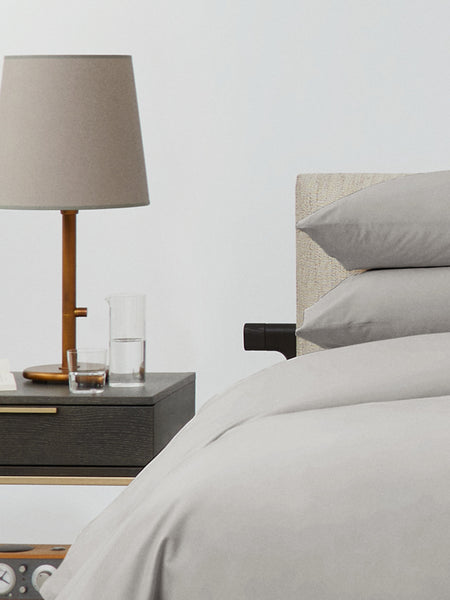 Bed dressed with a duvet in Spanish Slate color and two matching pillows.