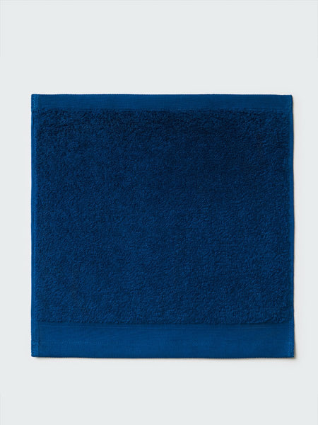 Close-up of a "Riviera Navy" colored bath wash cloth, visible fabric